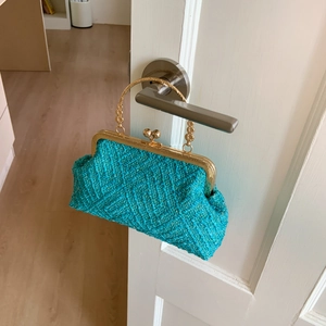 Lake blue tweed handbag with a gold hollowed-out metal handle and diamond weave pattern