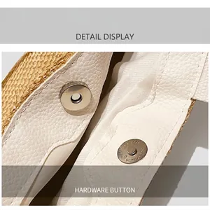 Macro detail of white pebble leather trim and silver magnetic clasp on a woven straw bag