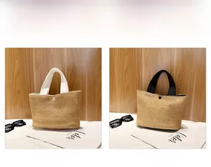 Detail view of woven straw tote bags in white and black with snap buttons