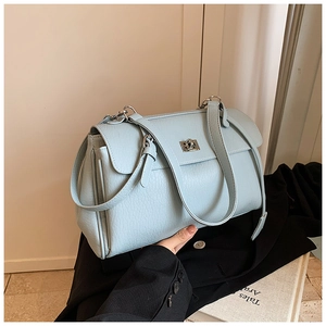 Close-up of light blue textured leather underarm bag with silver square twist lock closure