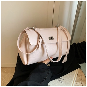 Detail of light pink textured leather handbag featuring silver rectangle twist lock