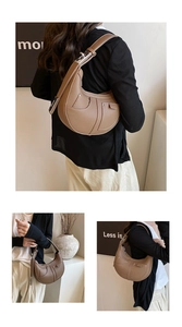 Detail of tan pebble leather hobo bag featuring contrast stitching and silver metal buckle