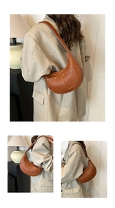 Detail of brown lychee grain leather hobo bag with decorative pockets and metallic rivets