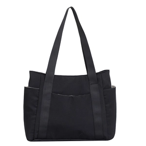 Minimalist black canvas tote bag with multiple pockets for casual daily commute