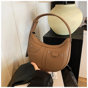 Detailed shot of brown pebbled leather hobo bag with silver rivets and double pocket design