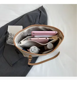 Detailed interior view showing spacious multi-compartment storage of the large tote bag
