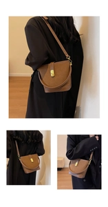 Three-way view of brown suede bucket bag with gold twist lock on shoulder and crossbody