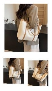 Detailed side view of a large cream tote bag with brown contrast straps and trim