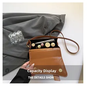 Internal capacity display of a brown vintage leather crossbody bag with cosmetics