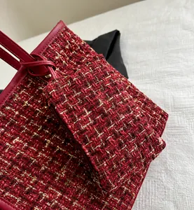 Detail of red tweed tote bag with leather trim and matching zip pouch set