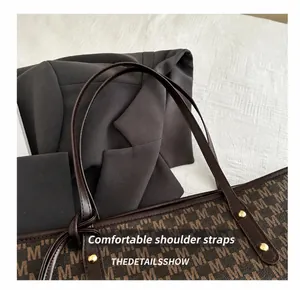 Close-up of durable shoulder straps and metal rivet detail on brown tote bag