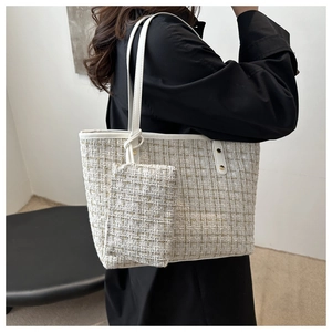 Détail du sac cabas en tweed avec pochette assortie et bandoulière en cuir blanc