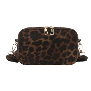 Leopard print crossbody camera bag with gold hardware and dual zippers on white background