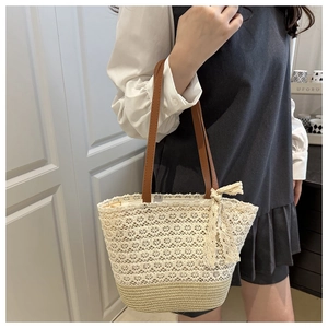 Close-up of handmade lace crochet tote with woven base and brown leather handles