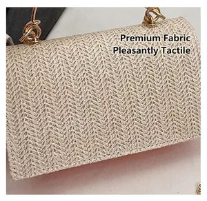 Detailed macro view of beige woven handbag texture with golden chain metal handles