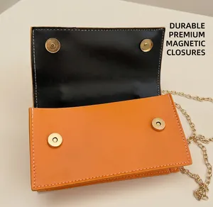 Close-up of dual-tone straw bag featuring gold magnetic buckles and a chain strap