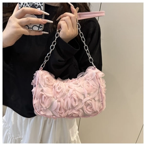 Detail of pink floral shoulder bag featuring 3D mesh rose petals and metal chain strap