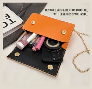Interior view of orange and black flap bag showing capacity for phone and cosmetics