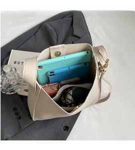 Large capacity off-white bucket bag with spacious interior for tablets and wallets