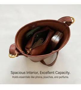 Top view of brown bucket bag interior showing large capacity and matching zipper pouch