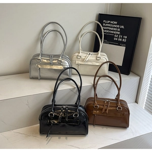 Chic Boston bags in silver, cream, black, and brown leather on marble display