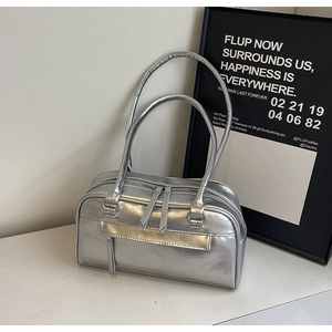 Detailed close-up of metallic silver hobo bag with dual zippers and wrinkled leather texture
