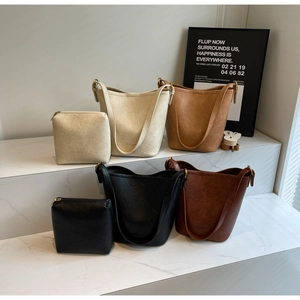 Detail of four retro textured PU leather bucket bags with matching square zipper pouches