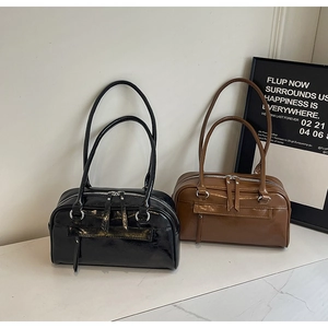 Close-up of sleek black and brown faux leather tote bags with polished silver zippers