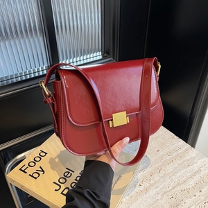 Red glossy patent leather square shoulder bag with gold clasp and adjustable strap