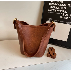 Detailed view of the brown retro bucket bag showing leather texture and branding