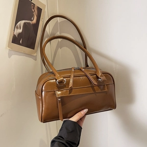 Retro brown shoulder bag with glossy finish and pillow shape for daily office commuting