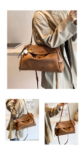 Detail of brown suede tote bag featuring a golden twist lock and decorative scarf charm