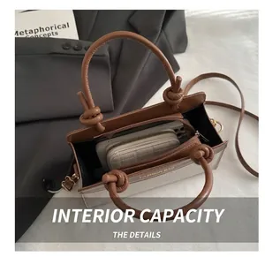 Interior view showing the capacity of this two-tone square bag for phone and wallet