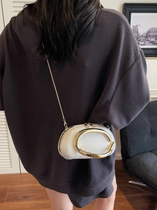 White faux leather mini bag with gold C-shaped metal clasp and chain shoulder strap