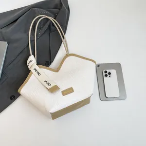 Top view of white woven tote bag with khaki trim showing its spacious internal capacity
