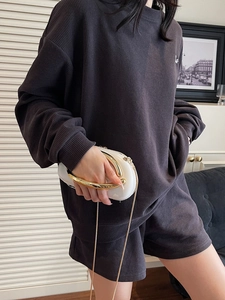 Dark grey waffle knit lounge set with oversized sweatshirt and metal handle clutch bag