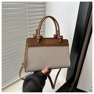 Detail of vintage contrast crossbody bag with canvas and leather patchwork handle