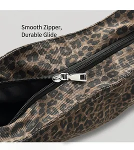 Detailed close-up of the smooth silver metal zipper on a leopard print tote bag
