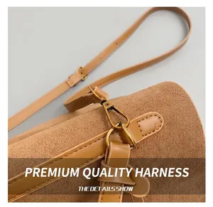 Detail of vintage gold metal hook on brown frosted leather tote bag with stitching