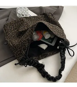 Detail of leopard print tote bag interior showing large capacity for iPad and umbrella
