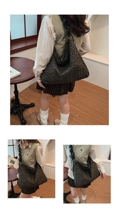 Detailed view of leopard print tote bag with black pleated shoulder strap and bow accent