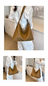 Detail of tan pebble leather hobo bag with wide shoulder strap and gold buckle