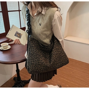 Detail of leopard print tote bag with stylish black scrunchie shoulder strap design