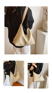 Detail of beige tote bag with litchi grain texture and adjustable wide shoulder strap