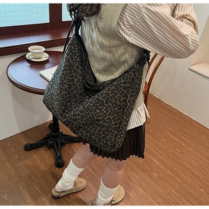 Chic leopard print canvas tote bag styled in a cozy cafe setting for urban casual look
