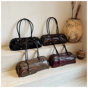Group display of retro cylindrical shoulder bags in black, caramel, brown and wine red colors