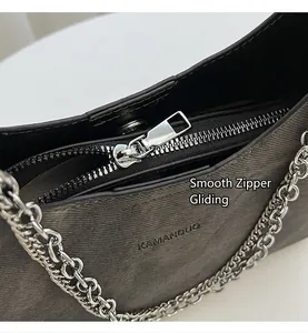 Nahaufnahme der dunkelgrauen Twill-Tasche mit silbernen Reißverschlüssen und Kettenriemen