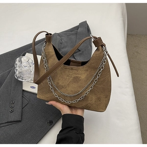 Detailaufnahme der braunen Hobo-Tasche mit silberner Doppelkette und Lederriemen