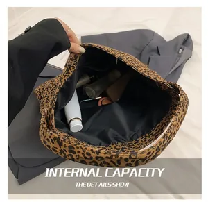 Detailed view of the large capacity leopard print tote bag showing daily essentials inside