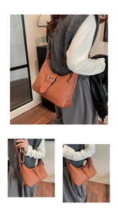 Detail showing the pleated vertical texture and silver metal buckle on the brown hobo bag